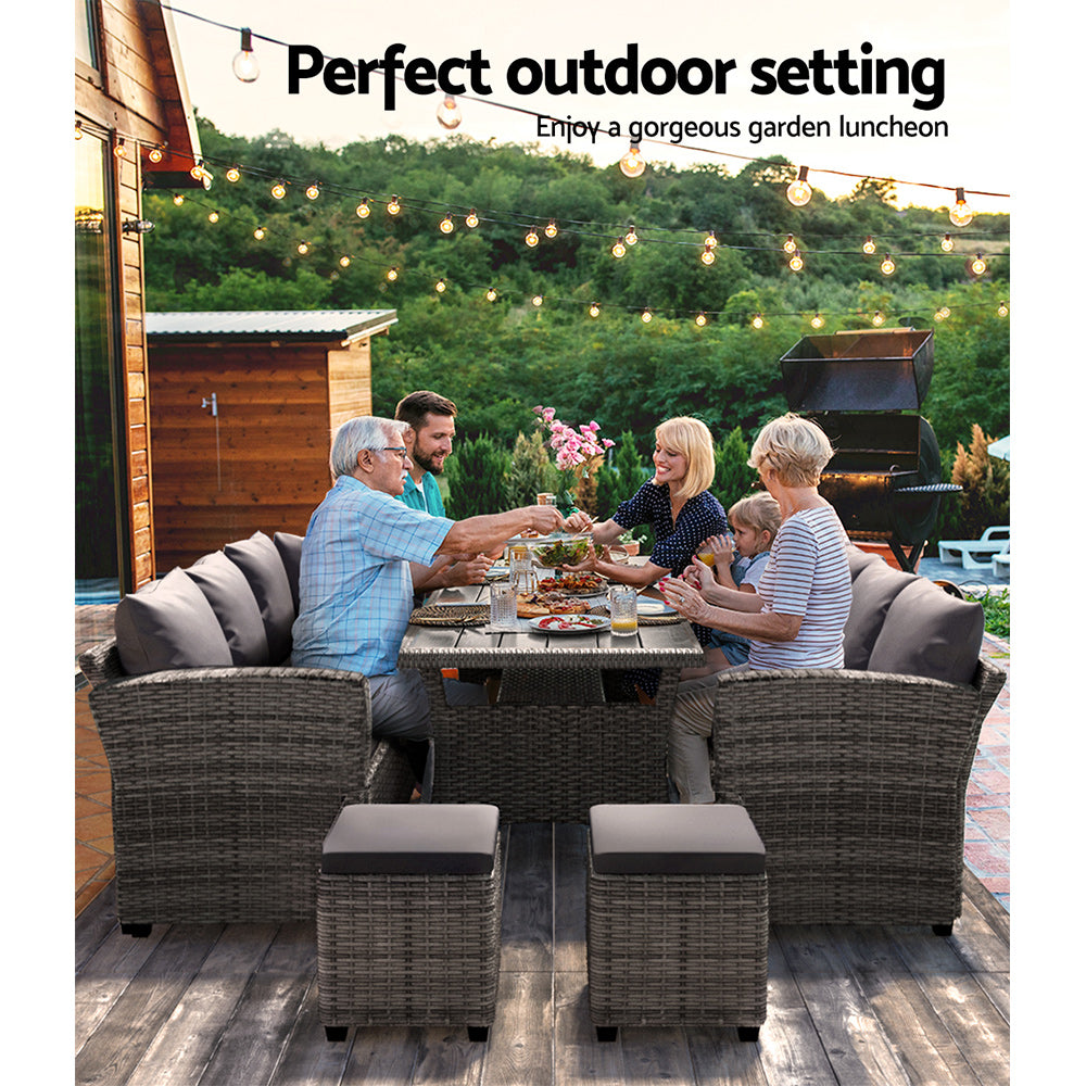 Family dining on wicker outdoor furniture under string lights in backyard garden setting