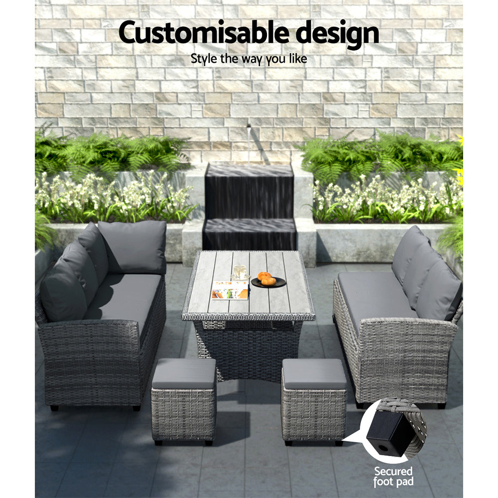 Grey wicker outdoor lounge set with cushions, table, and secured foot pads on patio