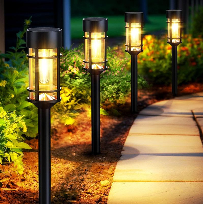 Solar garden path lights illuminating backyard walkway with warm glow, perfect for outdoor landscaping and evening ambiance.