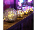 Crackle glass globe lights with warm LED fairy lights for outdoor garden decor
