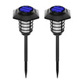 Solar-powered garden lights with blue panels and black stakes for outdoor yard illumination