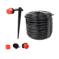 Drip irrigation kit with black tubing, red emitters, and garden stake for efficient plant watering