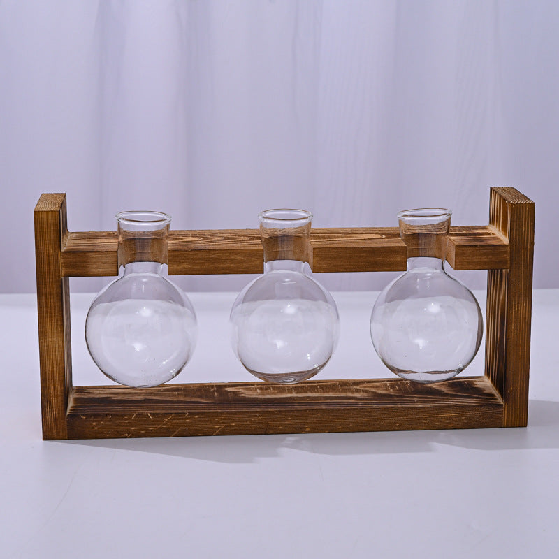 Wooden frame with three glass globe vases for outdoor garden decor